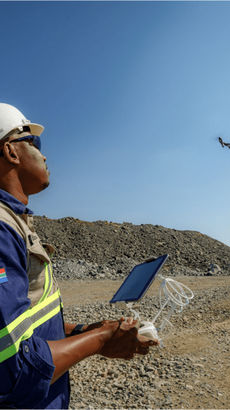 Man operating drone via remote control