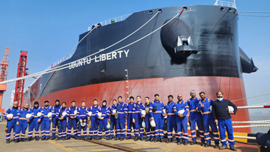 Seafarers standing in front of Ubuntu Liberty, 